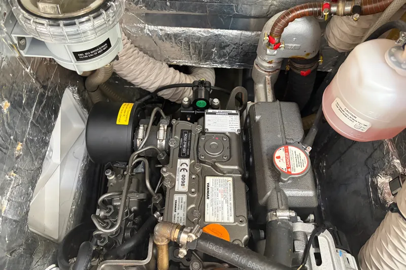 Slide: The Image of Engine compartment of a 2021 Beneteau Oceanis 30.1 sailboat, showcasing detailed mechanical components. - 18