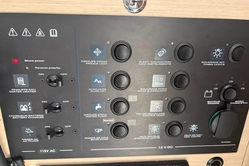 Slide: The Image of Control panel of a 2021 Beneteau Oceanis 30.1 yacht, featuring various switches and indicators. - 7