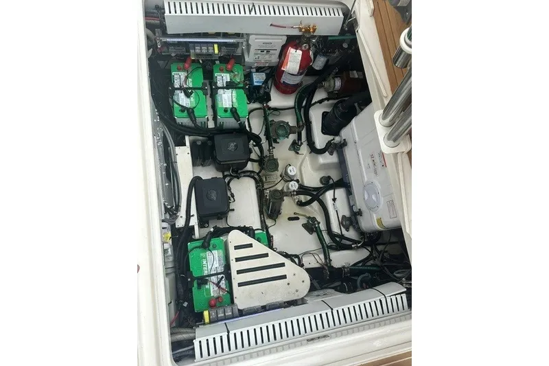 Slide: The Image of Engine compartment of a 2019 Boston Whaler 380 Realm with batteries and wiring. - 29