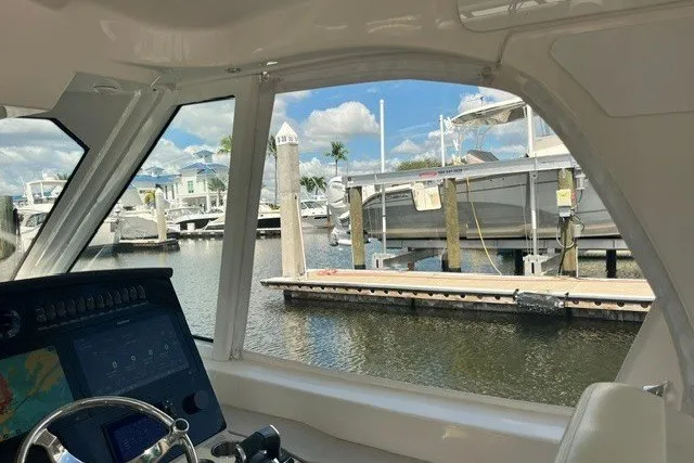 Slide: The Image of Interior view of 2019 Boston Whaler 380 Realm, overlooking marina with boats and docks. - 24