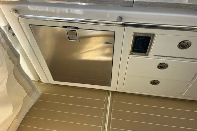 Slide: The Image of 2019 Boston Whaler 380 Realm interior with stainless steel appliances and cabinetry. - 21
