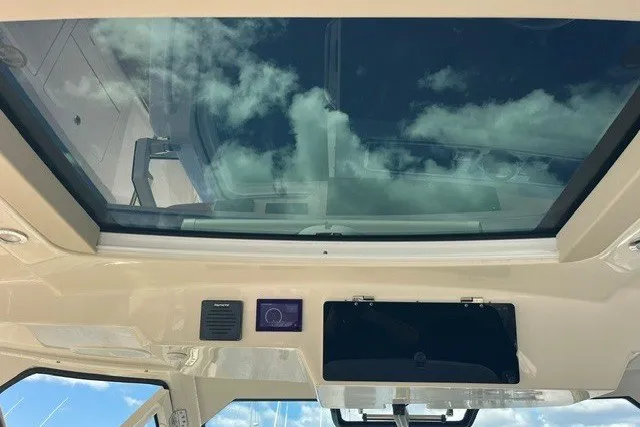 Slide: The Image of Interior view of 2019 Boston Whaler 380 Realm's glass roof with sky reflection. - 26