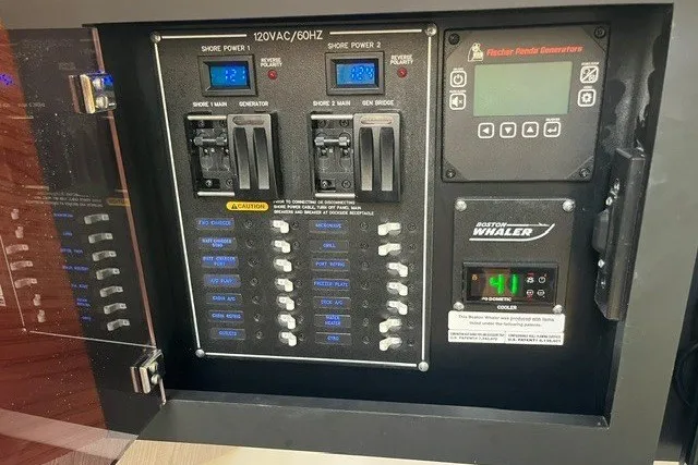 Slide: The Image of Electrical panel of 2019 Boston Whaler 380 Realm boat with generator controls. - 17