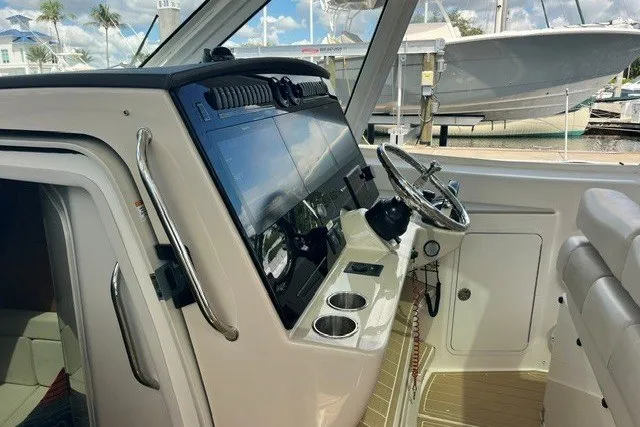 Slide: The Image of 2019 Boston Whaler 380 Realm helm with modern controls and steering wheel. - 28