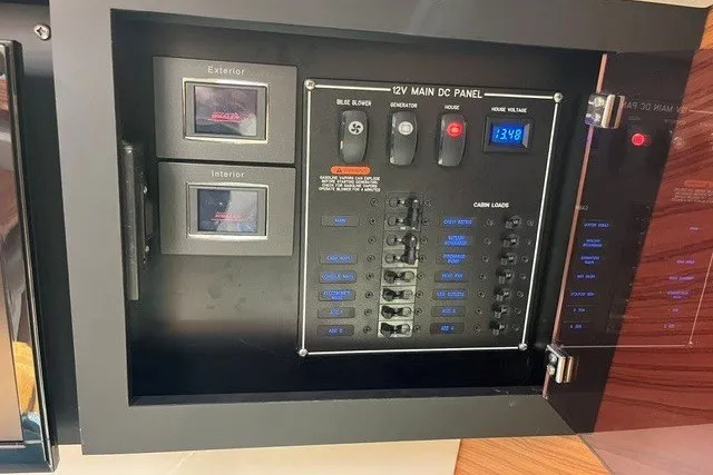 Slide: The Image of Control panel of a 2019 Boston Whaler 380 Realm boat, featuring 12V DC switches. - 16