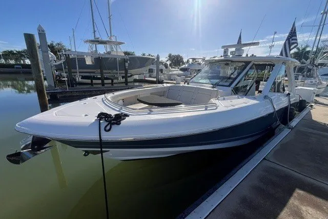 Slide: The Image of 2019 Boston Whaler 380 Realm docked at a marina under clear skies. - 31