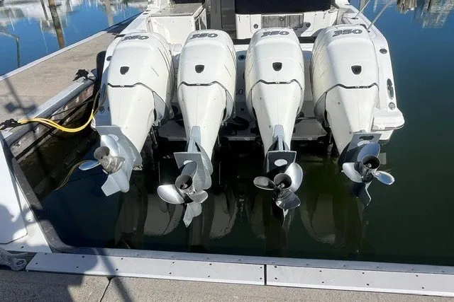Slide: The Image of 2019 Boston Whaler 380 Realm with four powerful outboard engines docked at marina. - 2