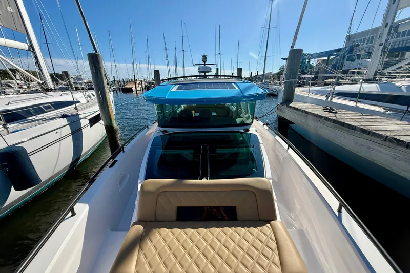 Slide: The Image of 2021 Axopar 37 XC Cross Cabin docked at marina, featuring sleek design and luxurious seating. - 4