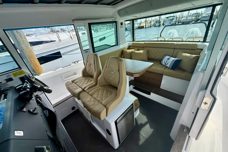 Slide: The Image of 2021 Axopar 37 XC Cross Cabin interior with plush seating and helm station. - 25