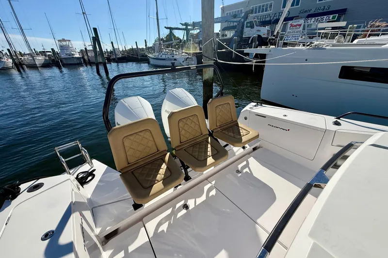 Slide: The Image of 2021 Axopar 37 XC Cross Cabin with tan seats docked at a marina. - 22