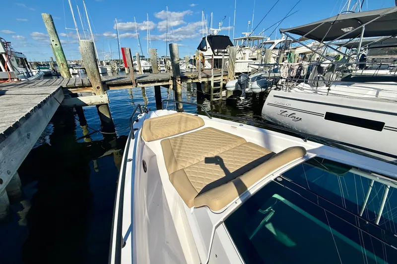 Slide: The Image of 2021 Axopar 37 XC Cross Cabin docked at marina with cushioned seating. - 8