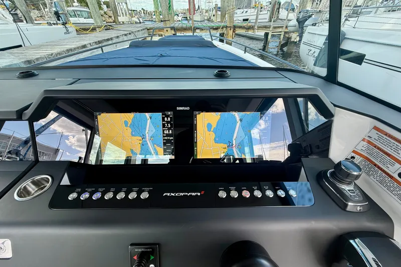 Slide: The Image of 2021 Axopar 37 XC Cross Cabin dashboard with navigation screens and controls. - 30