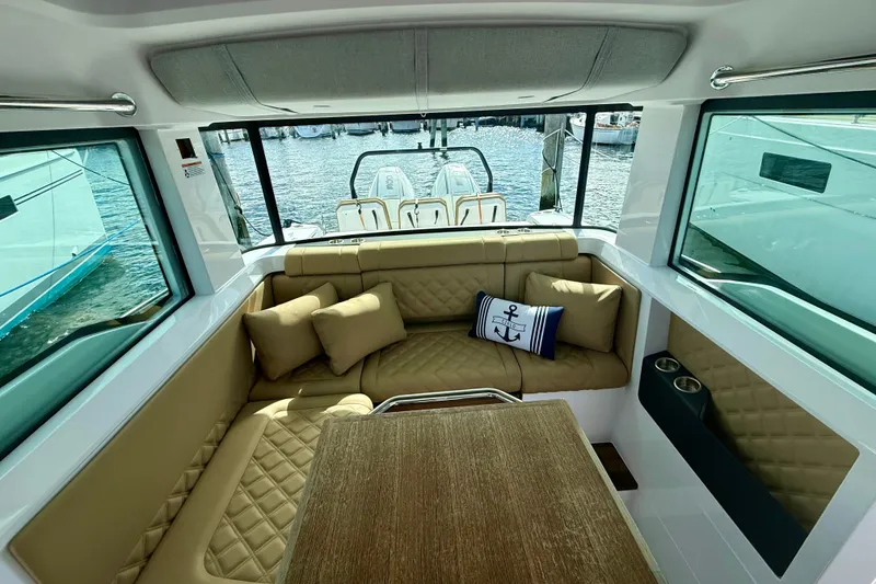 Slide: The Image of Luxurious interior of 2021 Axopar 37 XC Cross Cabin with plush seating and nautical decor. - 26