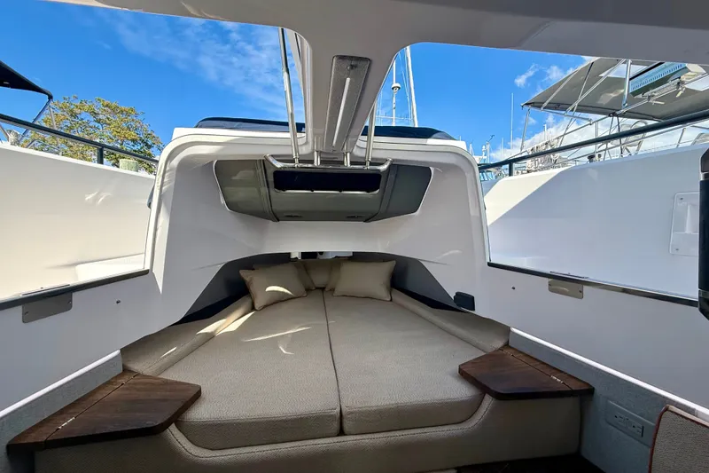Slide: The Image of 2021 Axopar 37 XC Cross Cabin interior with cozy sleeping area and cushions. - 37
