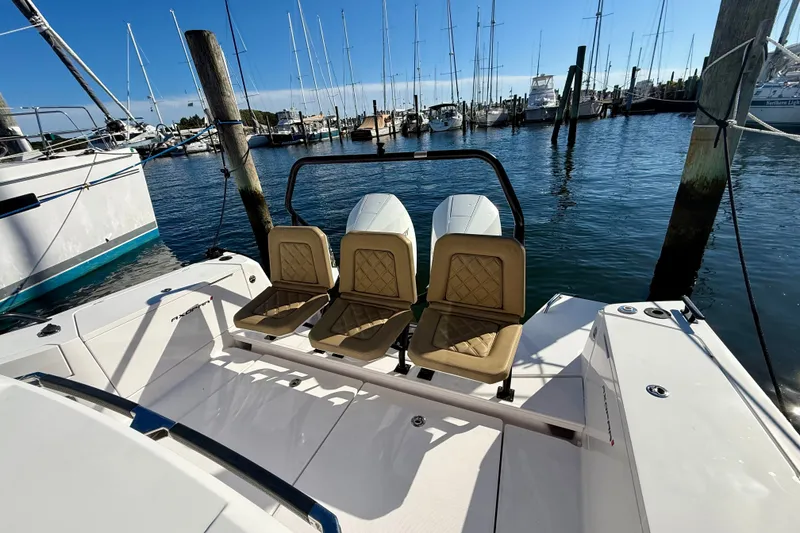 Slide: The Image of Axopar 37 XC Cross Cabin 2021 with three seats, docked at a marina. - 21