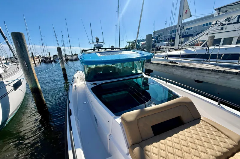 Slide: The Image of 2021 Axopar 37 XC Cross Cabin docked at a marina under clear blue skies. - 5