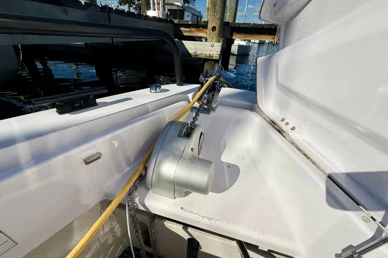 Slide: The Image of 2021 Axopar 37 XC Cross Cabin anchor compartment with chain and winch at dock. - 12