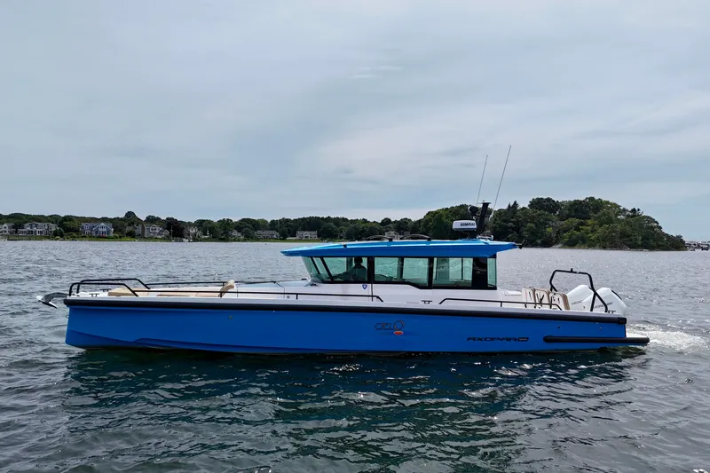 The Image of 2021 Axopar 37 XC Cross Cabin boat on calm water, side view. - 0