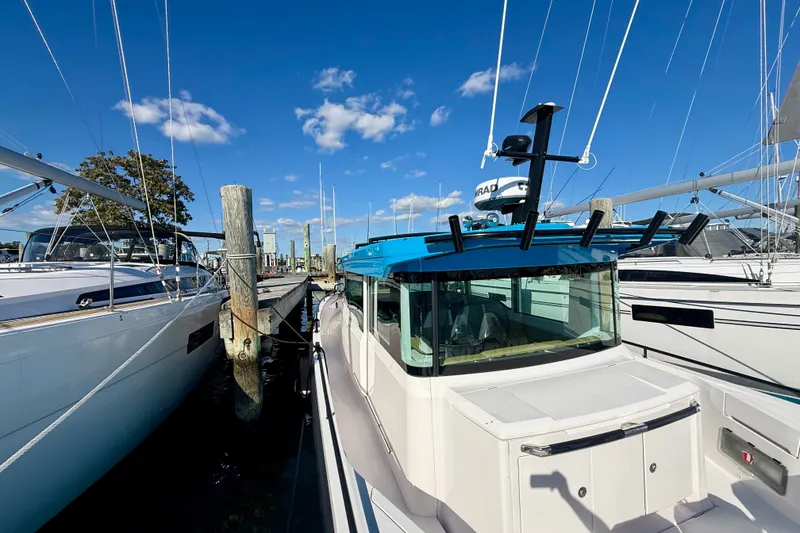 Slide: The Image of 2021 Axopar 37 XC Cross Cabin docked under clear blue sky. - 18