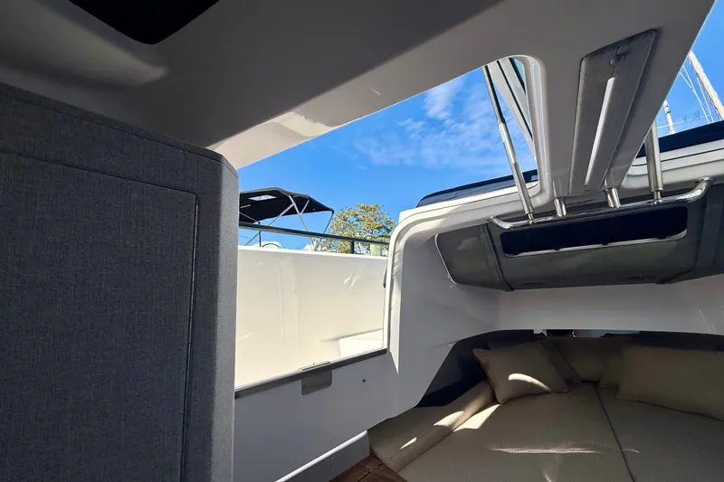 Slide: The Image of Interior view of 2021 Axopar 37 XC Cross Cabin with open roof and cushions. - 39