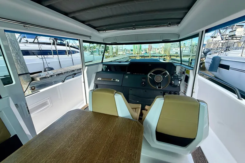 Slide: The Image of Interior view of 2021 Axopar 37 XC Cross Cabin boat, featuring helm and seating area. - 28