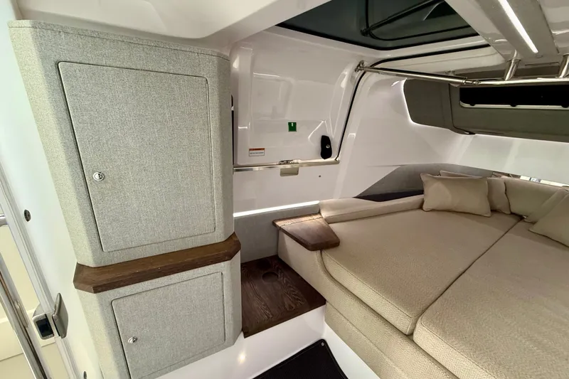 Slide: The Image of 2021 Axopar 37 XC Cross Cabin interior with cozy seating and storage cabinets. - 36