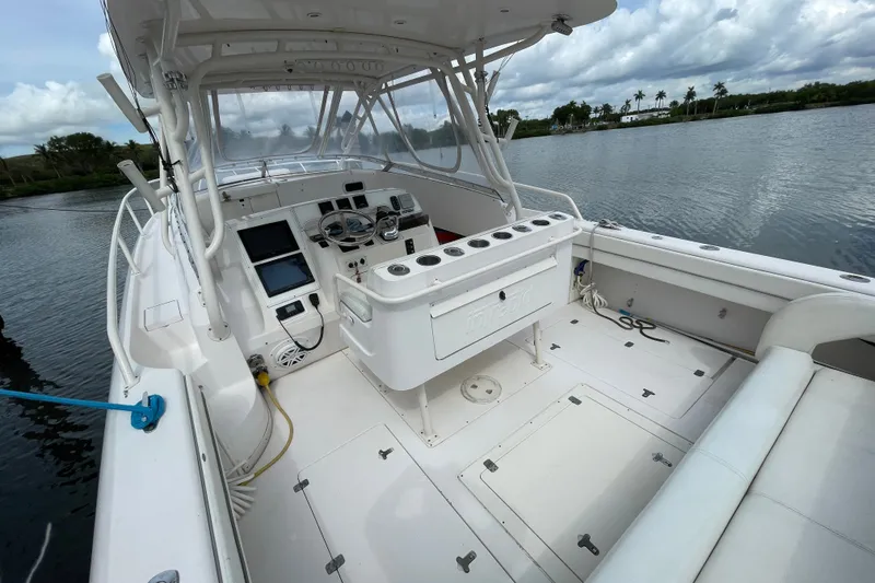 Slide: The Image of 2001 Intrepid 377 Walkaround boat interior with helm, seating, and water view. - 27