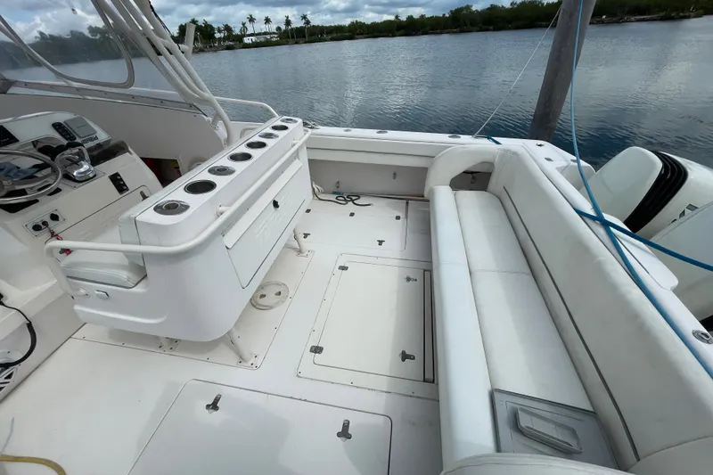 Slide: The Image of 2001 Intrepid 377 Walkaround boat interior with seating and control panel by the water. - 28