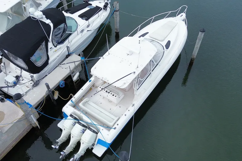Slide: The Image of Aerial view of a 2001 Intrepid 377 Walkaround boat docked at a marina. - 52