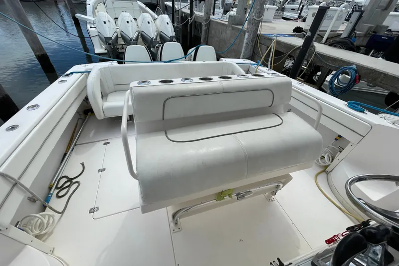 Slide: The Image of 2001 Intrepid 377 Walkaround boat interior with seating and fishing rod holders. - 30