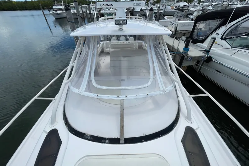 Slide: The Image of 2001 Intrepid 377 Walkaround boat docked at marina, featuring Garmin equipment. - 20