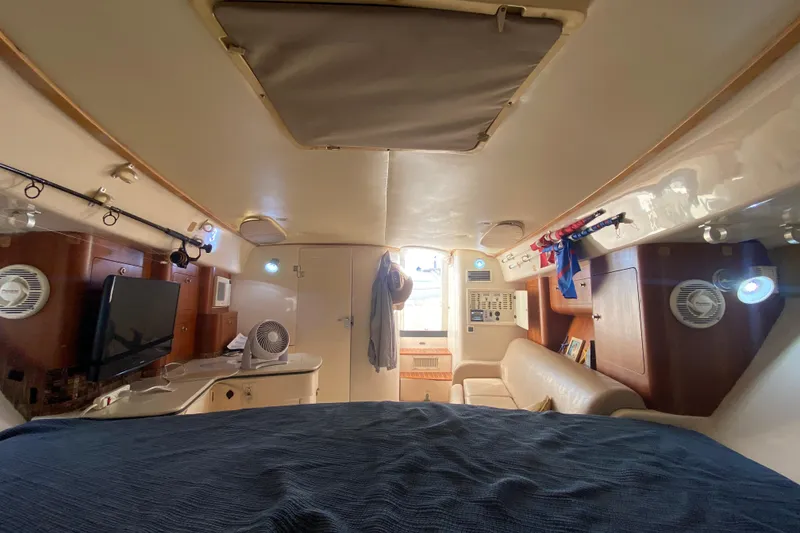Slide: The Image of Interior of a 2001 Intrepid 377 Walkaround boat, featuring cozy seating and modern amenities. - 38