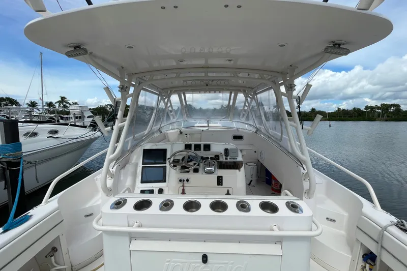 Slide: The Image of 2001 Intrepid 377 Walkaround boat cockpit with steering wheel and control panels. - 29