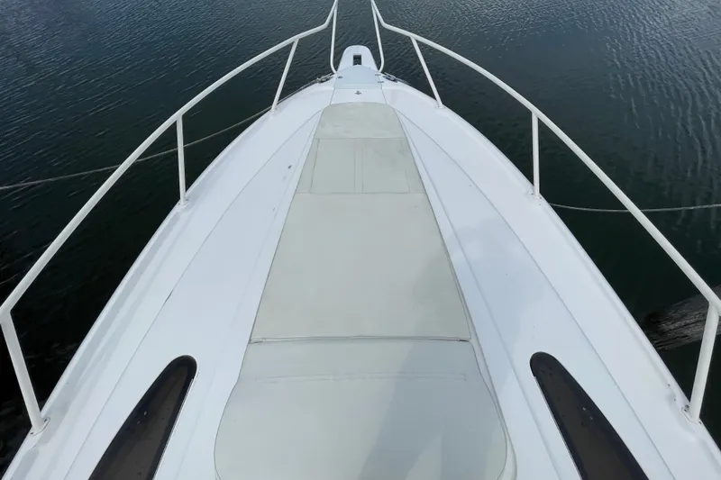 Slide: The Image of Bow view of 2001 Intrepid 377 Walkaround boat on calm water. - 19