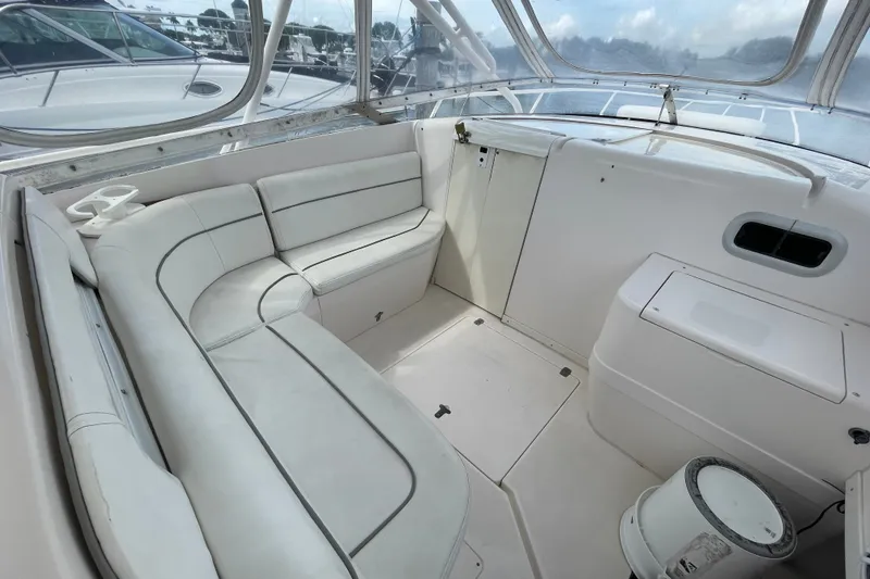 Slide: The Image of 2001 Intrepid 377 Walkaround boat interior with white seating and helm area. - 32