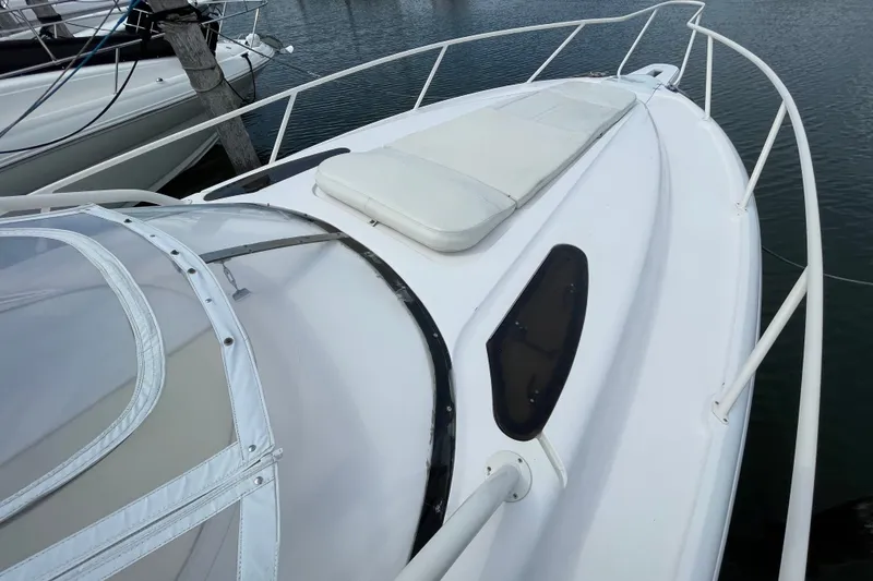 Slide: The Image of 2001 Intrepid 377 Walkaround boat deck with cushioned seating and railing. - 18
