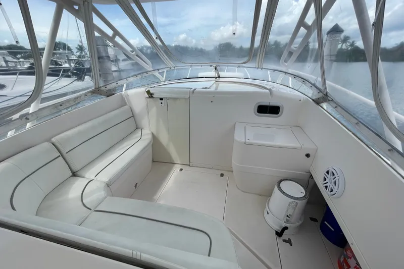 Slide: The Image of 2001 Intrepid 377 Walkaround boat interior with white seating and clear canopy. - 33