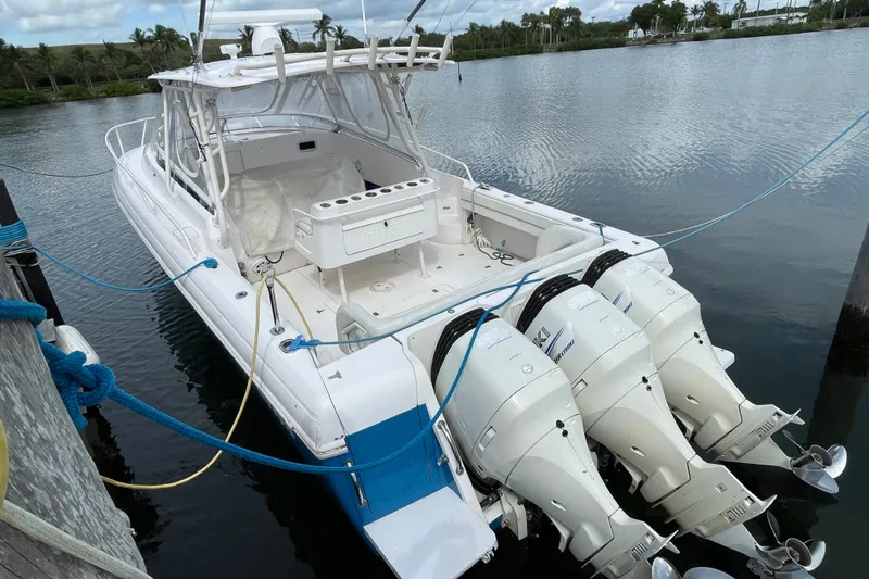 Slide: The Image of 2001 Intrepid 377 Walkaround boat docked with triple outboard engines. - 53