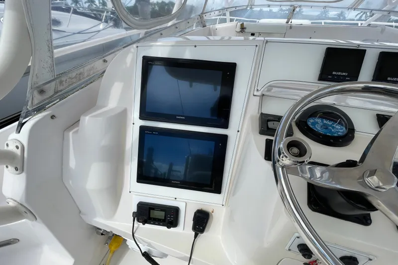Slide: The Image of Helm of 2001 Intrepid 377 Walkaround with Garmin displays and Suzuki controls. - 48