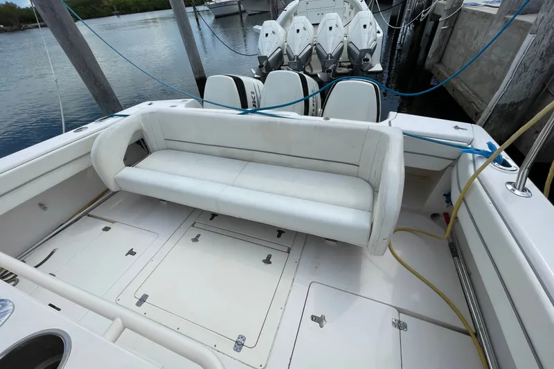 Slide: The Image of 2001 Intrepid 377 Walkaround boat with white seating and multiple outboard engines. - 26