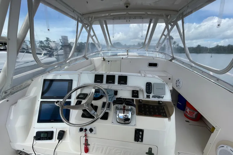Slide: The Image of 2001 Intrepid 377 Walkaround boat cockpit with modern navigation equipment and steering wheel. - 31