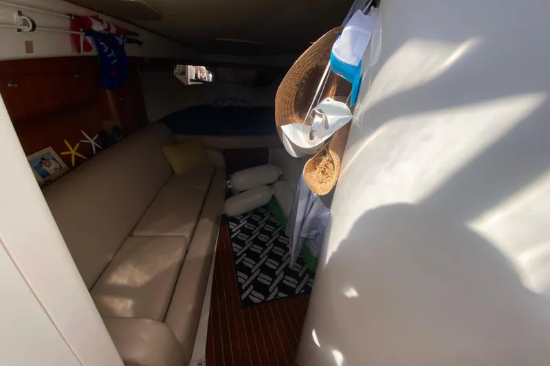 Slide: The Image of Interior of 2001 Intrepid 377 Walkaround boat with cozy seating and nautical decor. - 37