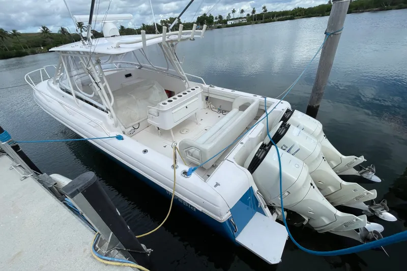 Slide: The Image of 2001 Intrepid 377 Walkaround boat docked with triple outboard engines. - 23