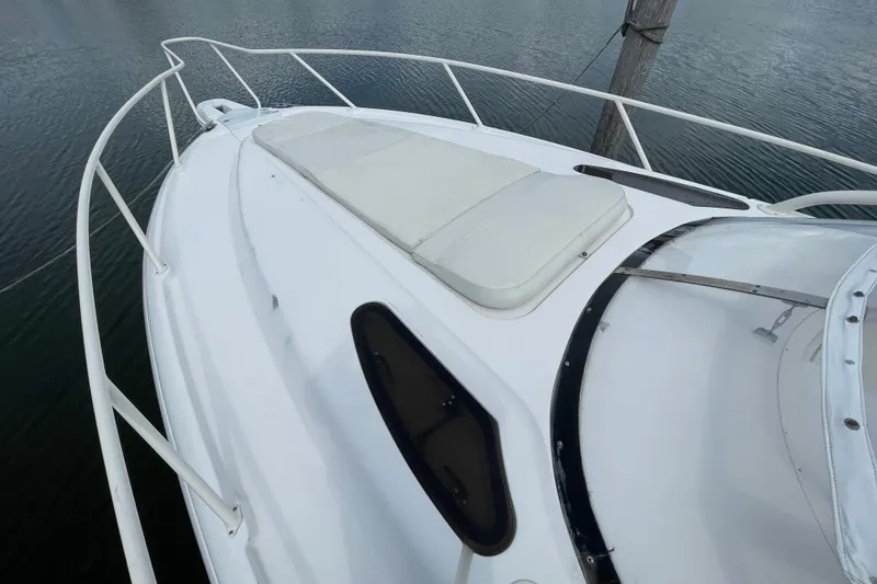 Slide: The Image of 2001 Intrepid 377 Walkaround boat deck with cushioned seating and railing. - 17