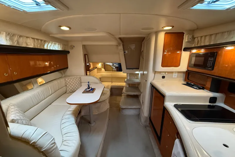 Slide: The Image of Luxurious interior of 2000 Sea Ray 340 Sundancer yacht with cozy seating and modern amenities. - 49