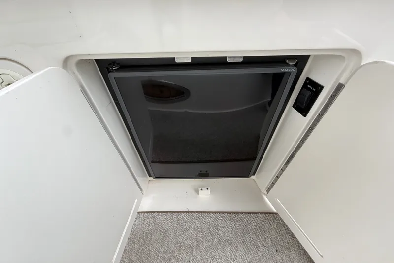 Slide: The Image of Compact refrigerator on a 2000 Sea Ray 340 Sundancer boat, with open cabinet doors. - 19
