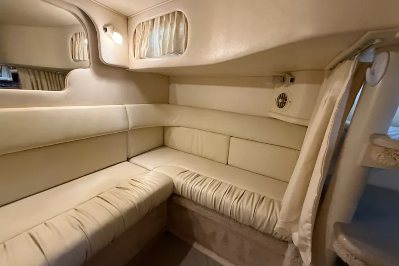 Slide: The Image of Interior of 2000 Sea Ray 340 Sundancer with beige seating and curtains. - 53