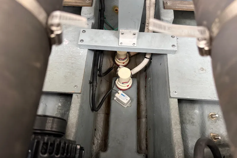 Slide: The Image of Engine compartment of a 2000 Sea Ray 340 Sundancer boat, showing mechanical components. - 69