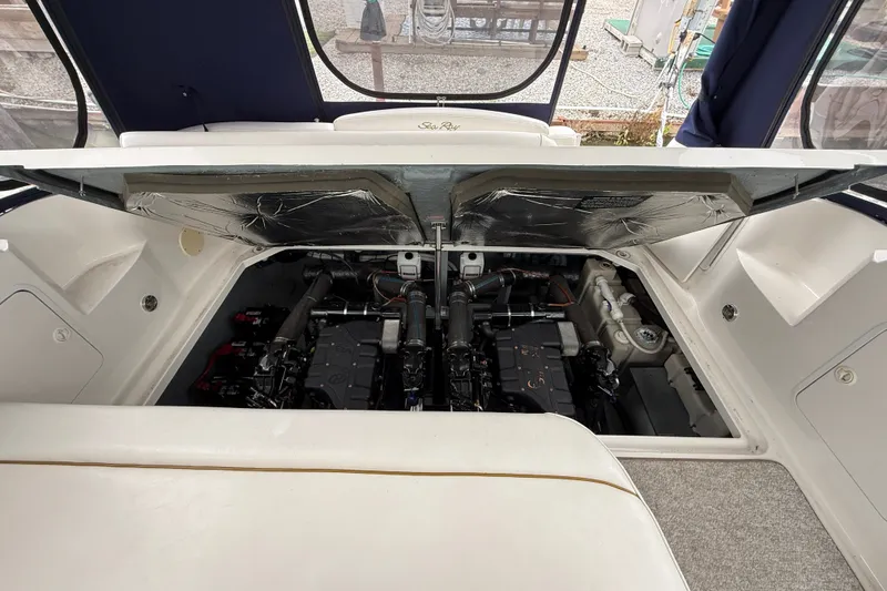 Slide: The Image of Engine compartment of a 2000 Sea Ray 340 Sundancer boat, showcasing dual engines. - 57
