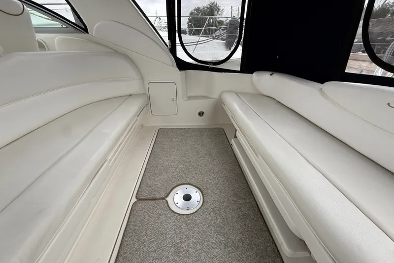 Slide: The Image of Interior seating area of 2000 Sea Ray 340 Sundancer boat with white upholstery. - 10